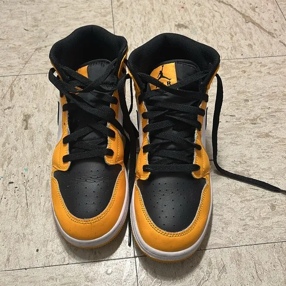 Black and yellow high top shoes