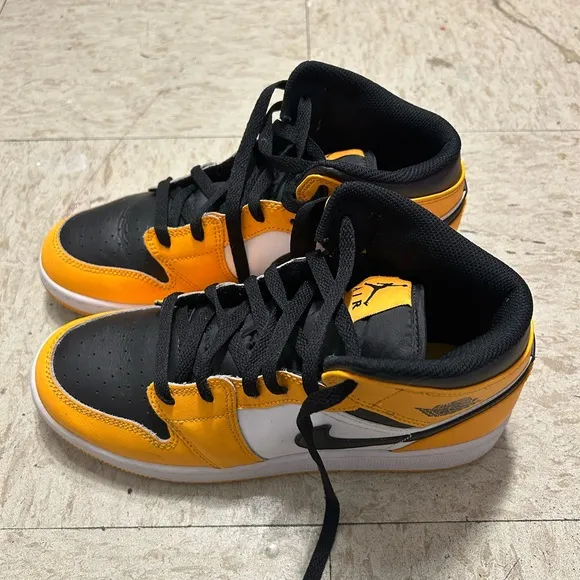Black and yellow high top shoes