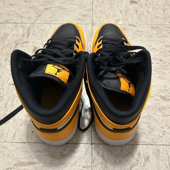 Black and yellow high top shoes