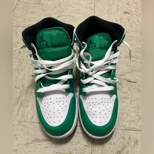 Green and white high top shoes